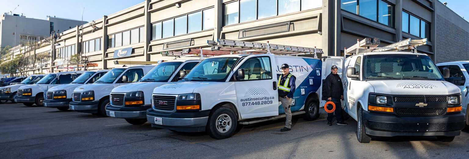 Row of security service vans with logos.