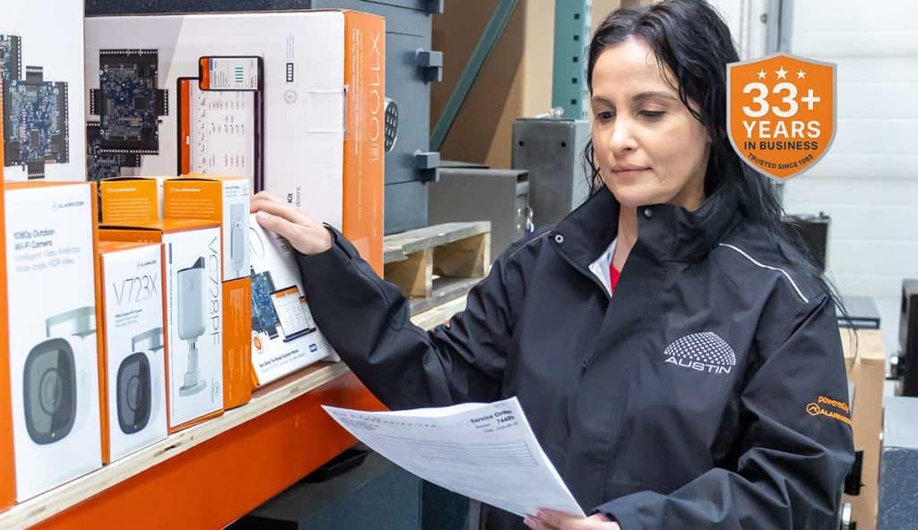 Warehouse employee examining inventory with checklist.