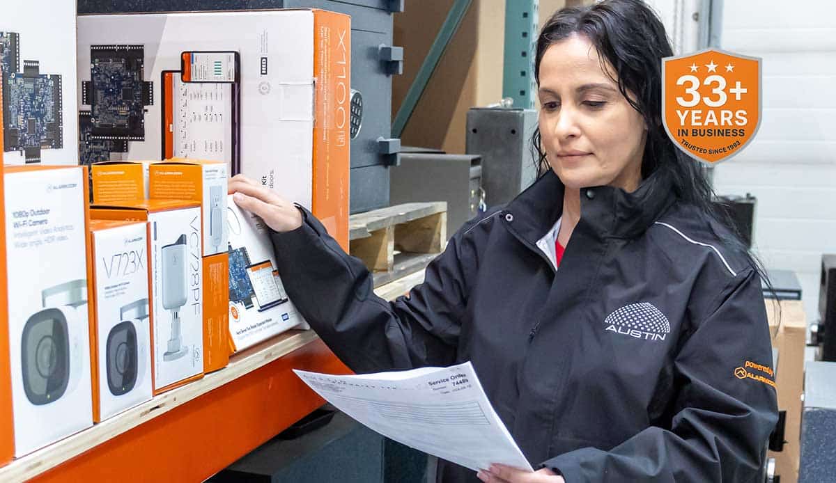 Warehouse employee examining inventory with checklist.