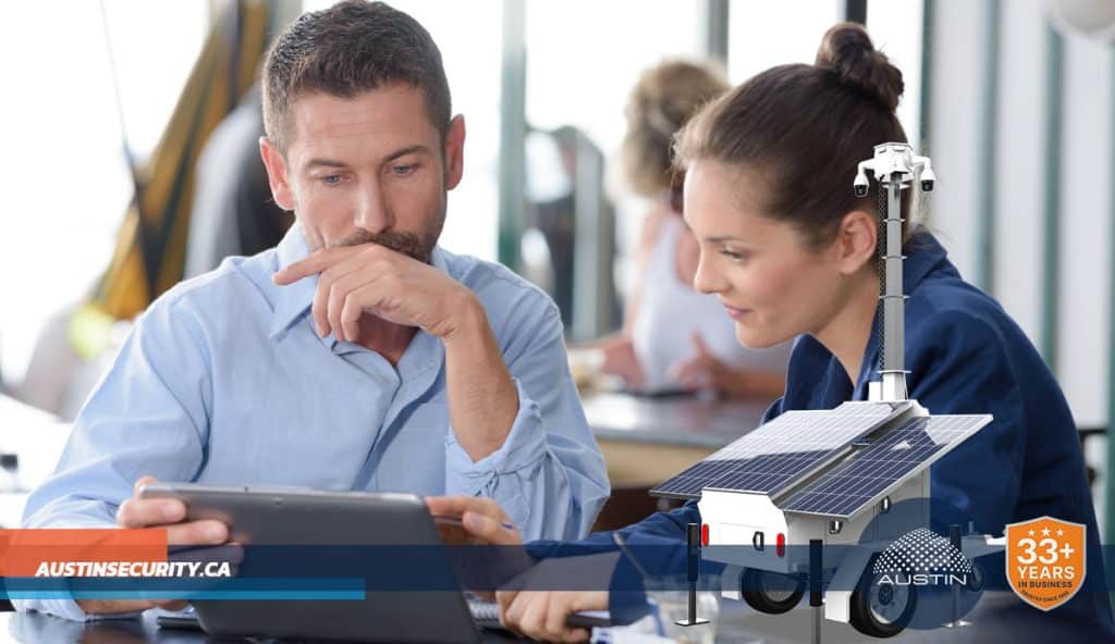 Two people discussing solar-powered security technology.